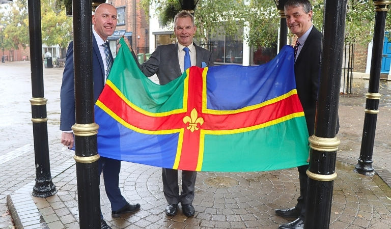 Greater Lincolnshire council leaders pictured with the Lincolnshire flag in Brigg